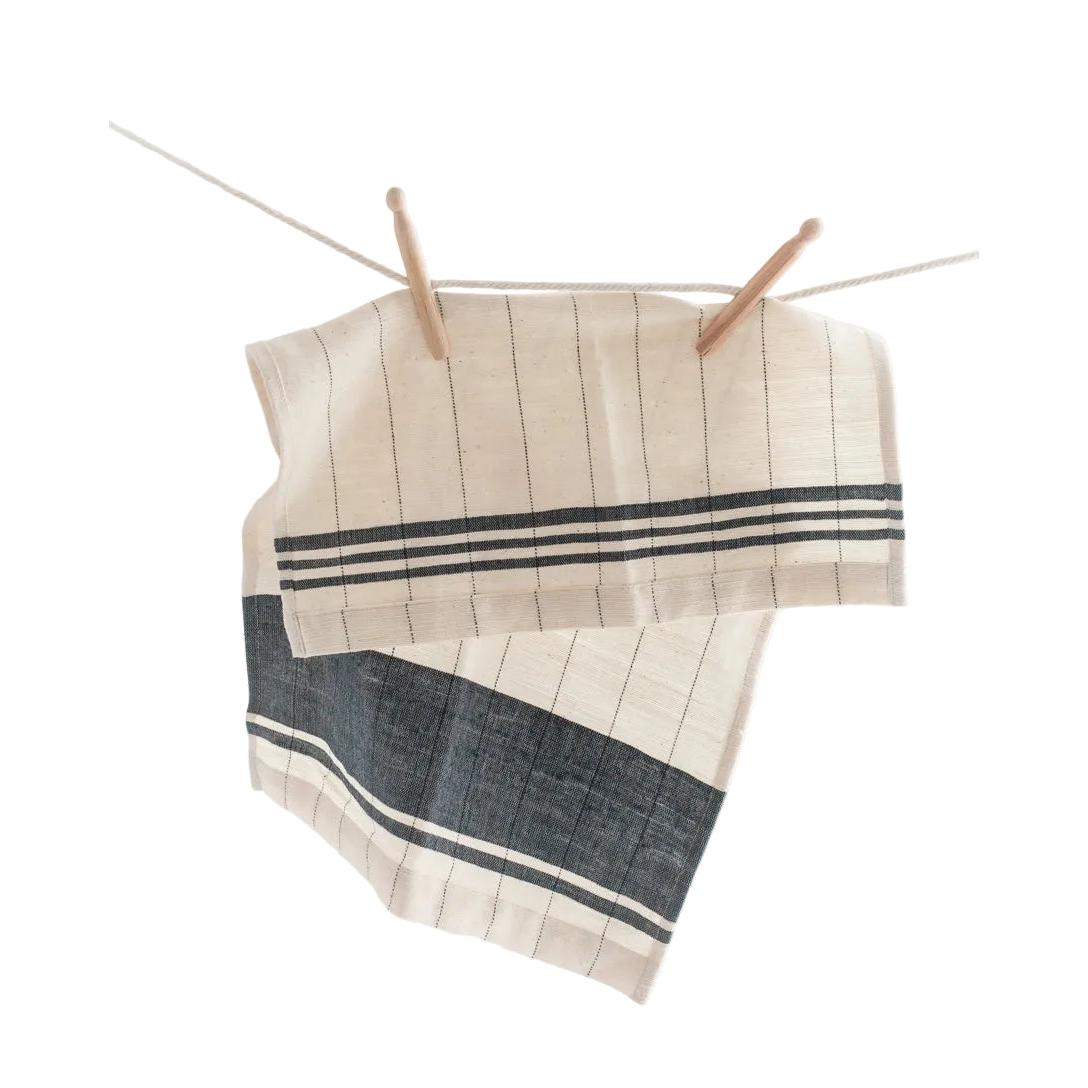 Striped towel hanging on a clothesline against a white background
