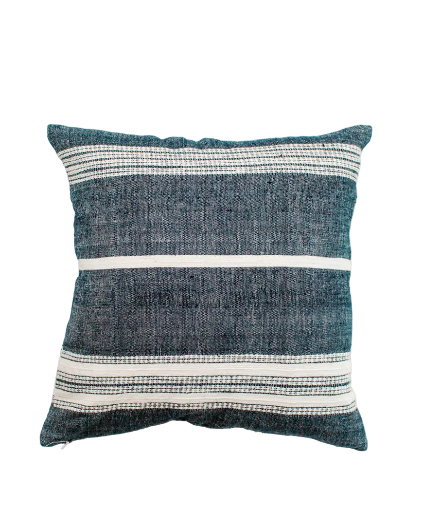 Textured blue pillow with white stripes on a white background
