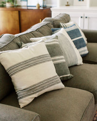 Gray sofa with patterned cushions in a living room setting