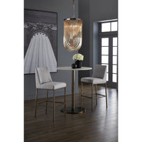 Modern dining area with a round table and two chairs under a stylish pendant light.