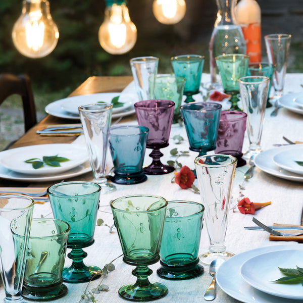 Colorful glassware on a table with outdoor setting