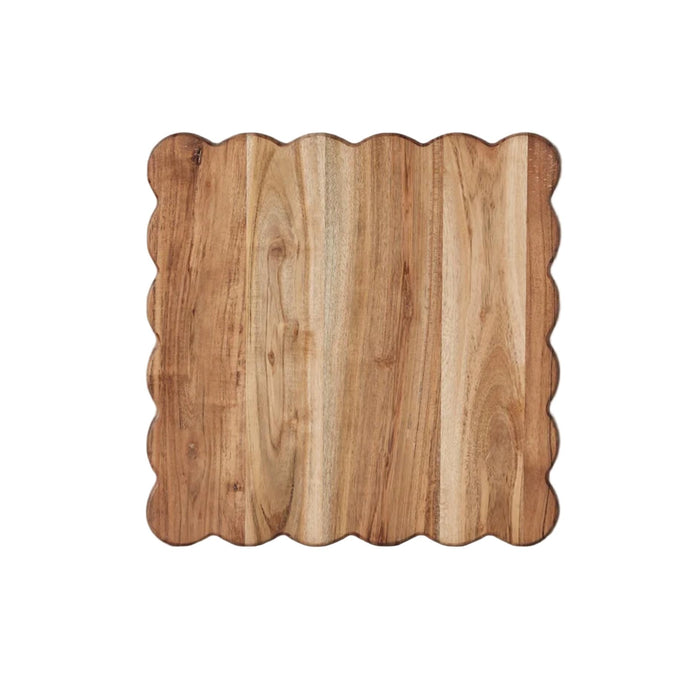 Square acacia wood cutting board with elegant scalloped edges, natural wood grain.