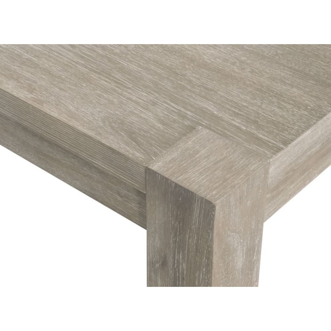 Adler natural gray acacia wood extension dining table with textured finish and sturdy leg detail.