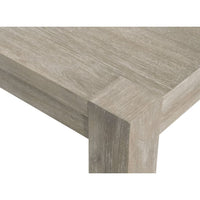 Adler natural gray acacia wood extension dining table with textured finish and sturdy leg detail.