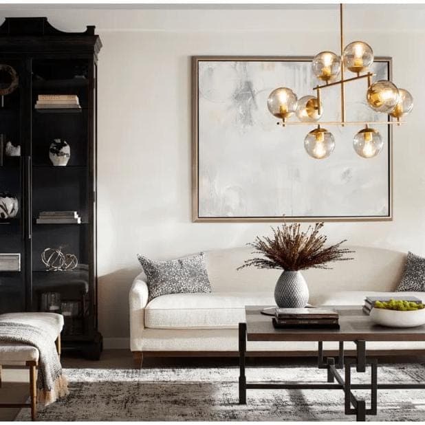 Aiden Aged Brass Globe Chandelier with eight spherical glass lights and gilded linear frames.