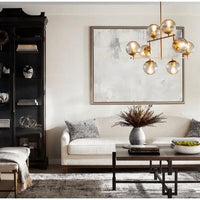 Aiden Aged Brass Globe Chandelier with eight spherical glass lights and gilded linear frames.