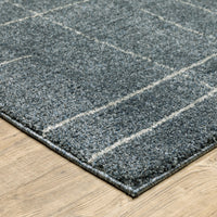 Alton Blue & Beige Casual Rug, power-loomed polyester with a subtle grid pattern on a light wood floor.