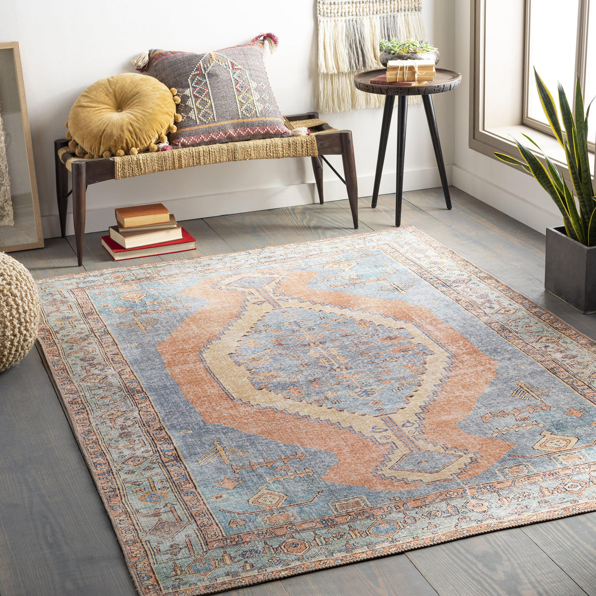 Amelie Blue & Coral Chenille Washable Rug with traditional design on a dark wood floor.