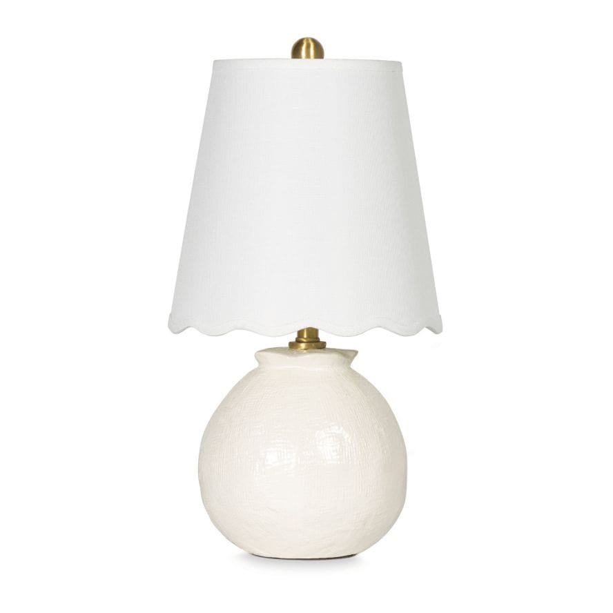 Amoria Mini Lamp with a white ceramic body, natural brass hardware, and a wavy scallop-like linen shade.