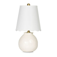 Amoria Mini Lamp with a white ceramic body, natural brass hardware, and a wavy scallop-like linen shade.