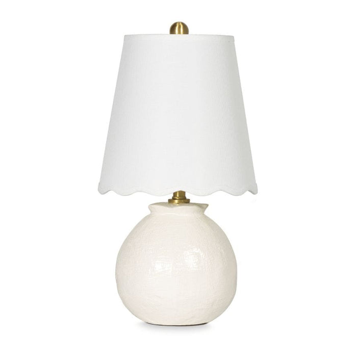 Amoria Mini Lamp with a white ceramic body, natural brass hardware, and a wavy scallop-like linen shade.