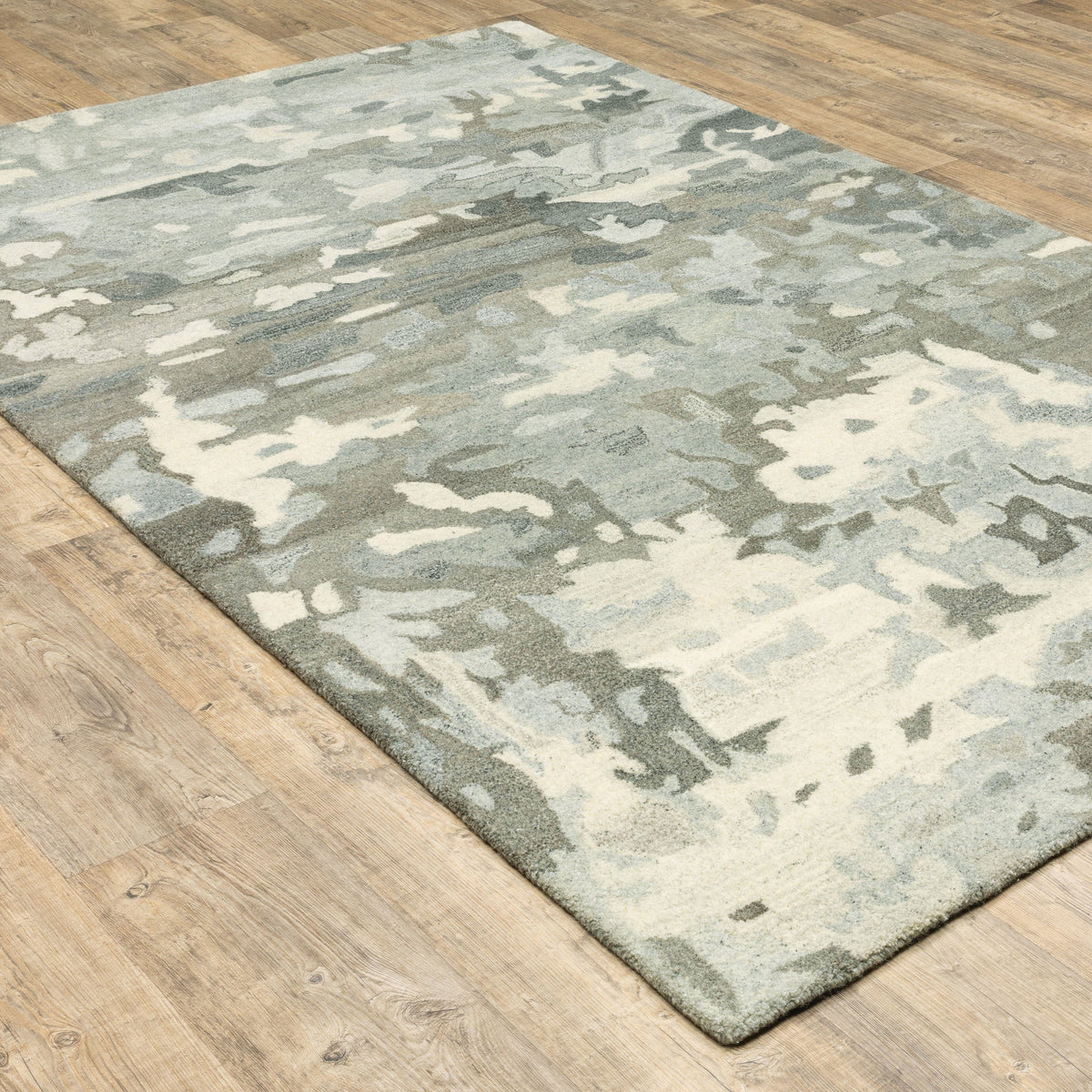Handmade Anastasia Grey & Charcoal contemporary wool rug with modernized traditional patterns on a wood floor.