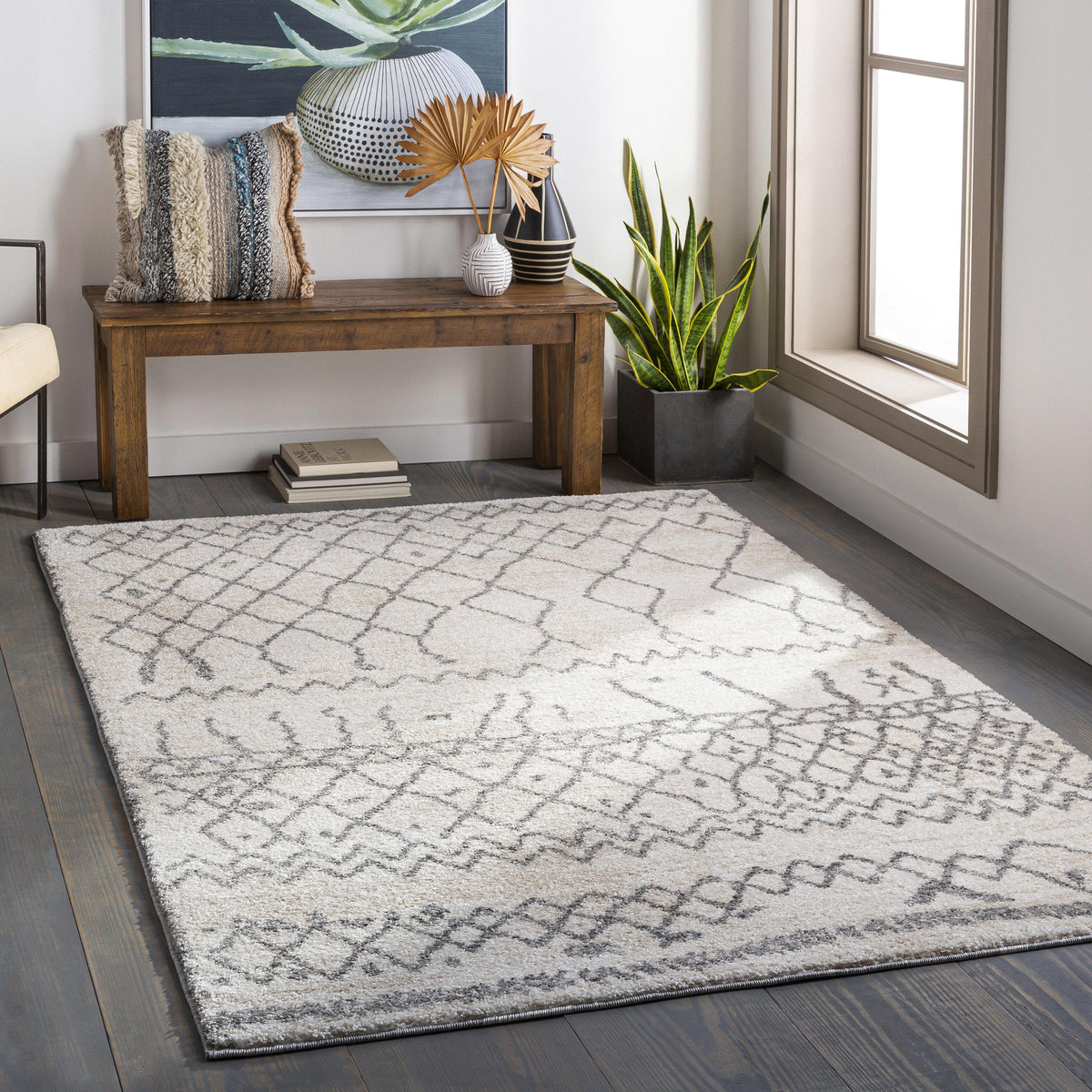 Andorra Charcoal & Beige polypropylene rug with a globally inspired geometric design on dark wood floors.