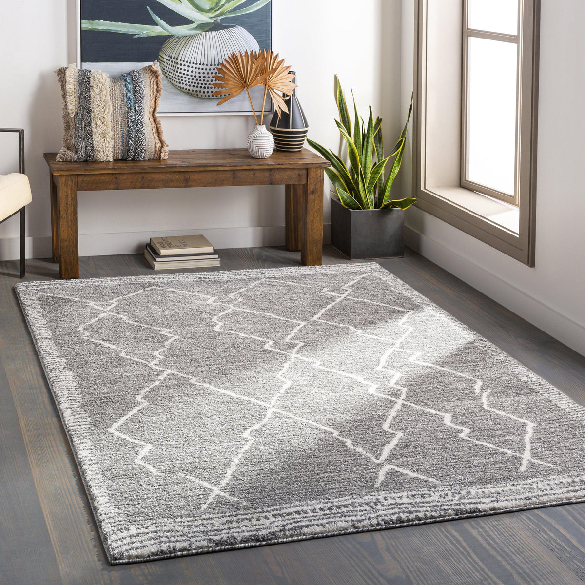 Andorra Charcoal & White Rug with a geometric pattern, made of polypropylene, on a dark wood floor.