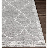 Andorra Charcoal & White polypropylene rug with a global geometric pattern on dark wood flooring.