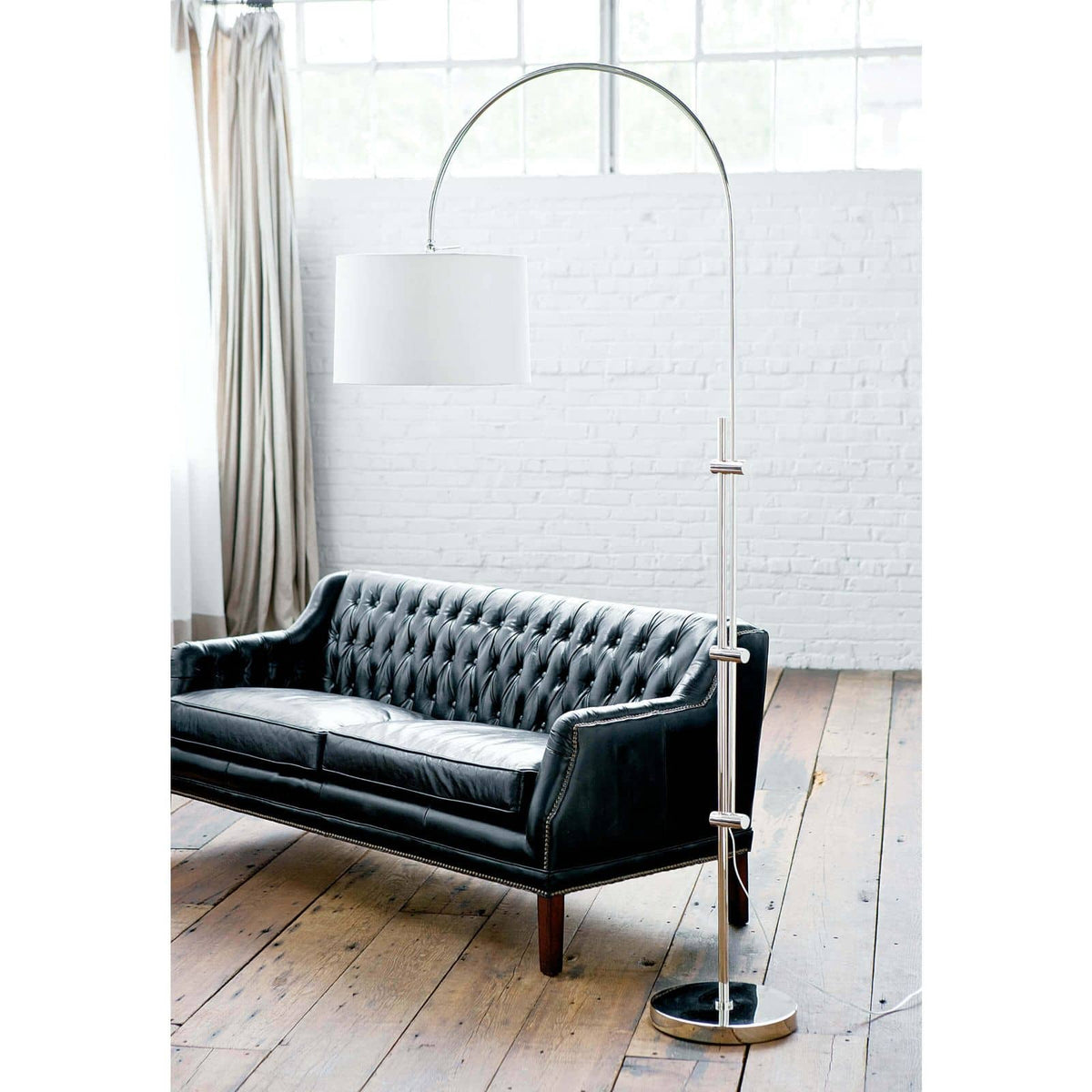 Modern 84" tall arc floor lamp with a metallic adjustable base and a white linen shade.