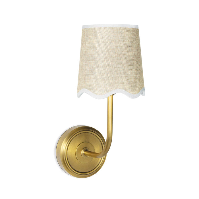 Ariel natural brass sconce with a woven linen shade and scalloped trim.