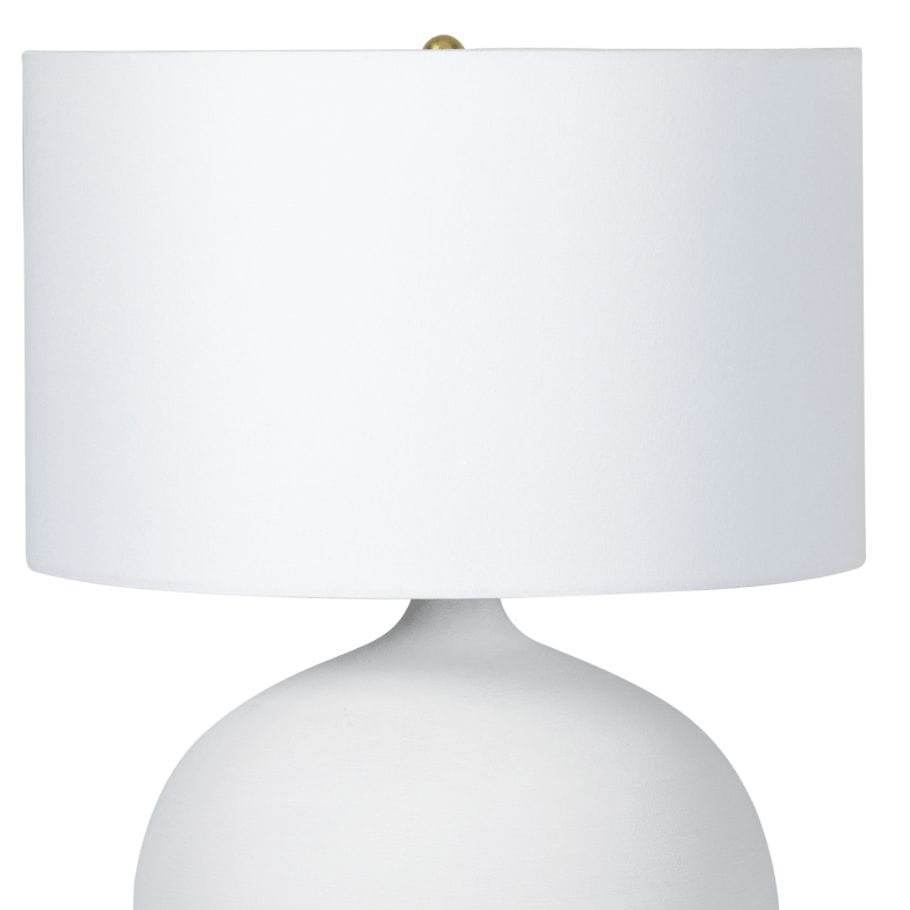 Arlo Ceramic Table Lamp with a smooth white rounded ceramic base, natural brass hardware, and a crisp natural linen shade.