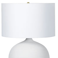 Arlo Ceramic Table Lamp with a smooth white rounded ceramic base, natural brass hardware, and a crisp natural linen shade.