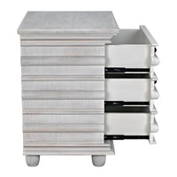 Ascona Side Table in white wash mahogany with fluted design, brass pulls, and three open drawers.