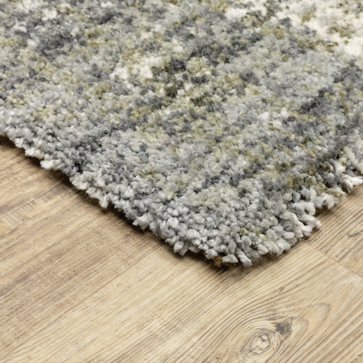 Close-up of a soft, textured Aspen Grey & Ivory Contemporary Striped Rug on a wood floor.