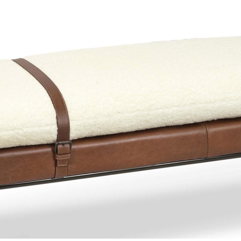 Aspen bench with cream boucle wool top, brown leather base, and decorative leather strap.