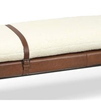 Aspen bench with cream boucle wool top, brown leather base, and decorative leather strap.