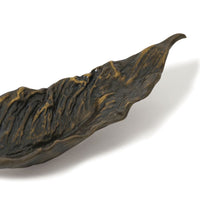 Dark bronze cast iron leaf-shaped bowl with raised organic texture, 13.5" wide.