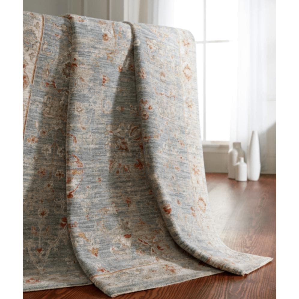 Avant Garde Blue & Light Beige machine-woven rug with traditional design, medium pile, draped over furniture.