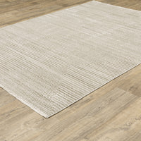 Bauer Beige & Ivory Casual Rug, 100% recycled PET yarn, with a subtle geometric pattern on wood floor.