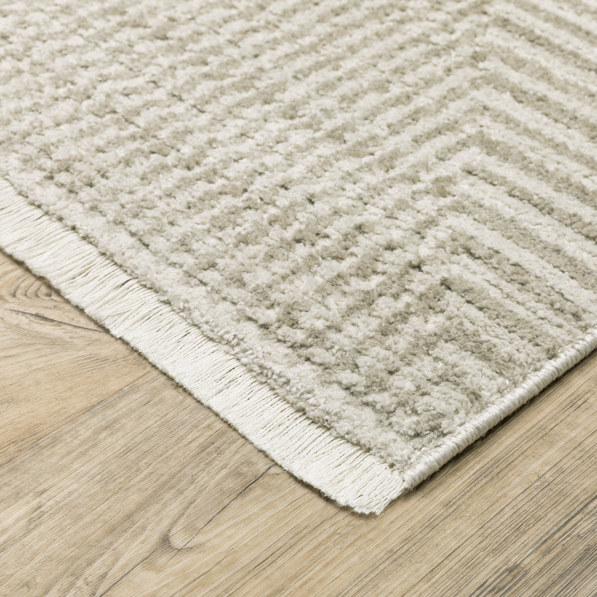 Bauer Beige & Ivory Casual Rug, made from recycled PET yarn, featuring a textured chevron pattern and fringe.