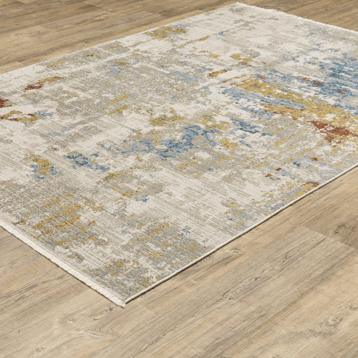 Bauer Beige Multi-Colored Contemporary Rug with abstract blue, gold, and rust accents on a light wood floor.