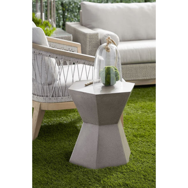 Slate gray concrete accent table with a unique geometric design, shown outdoors on artificial grass.