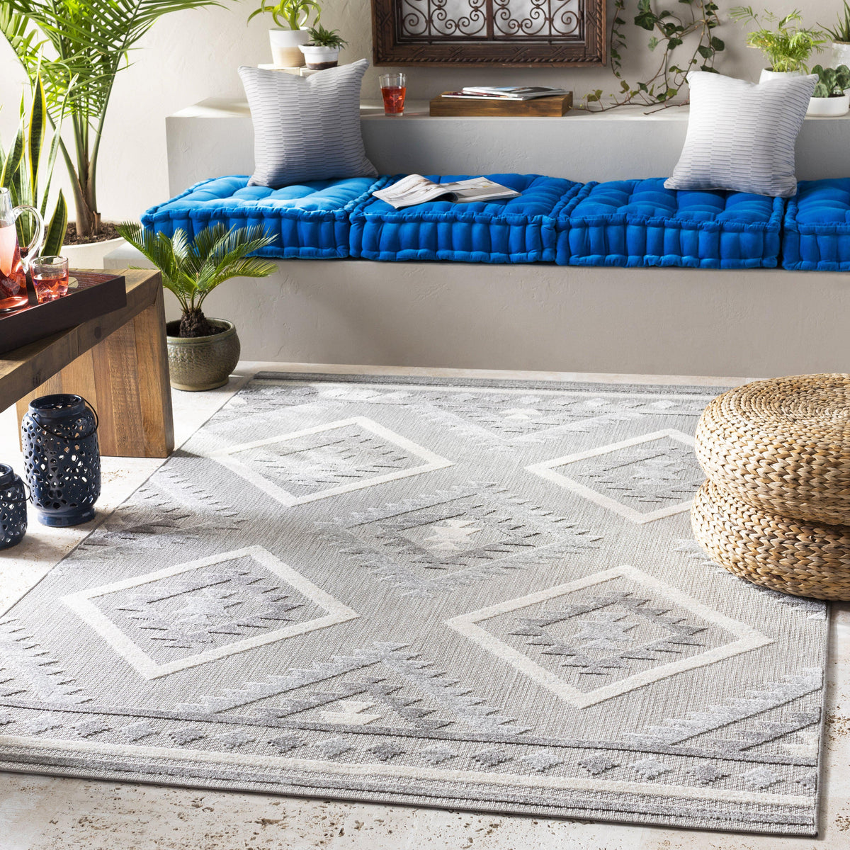 Big Sur Gray Cream indoor/outdoor rug with geometric diamond pattern on a patio.