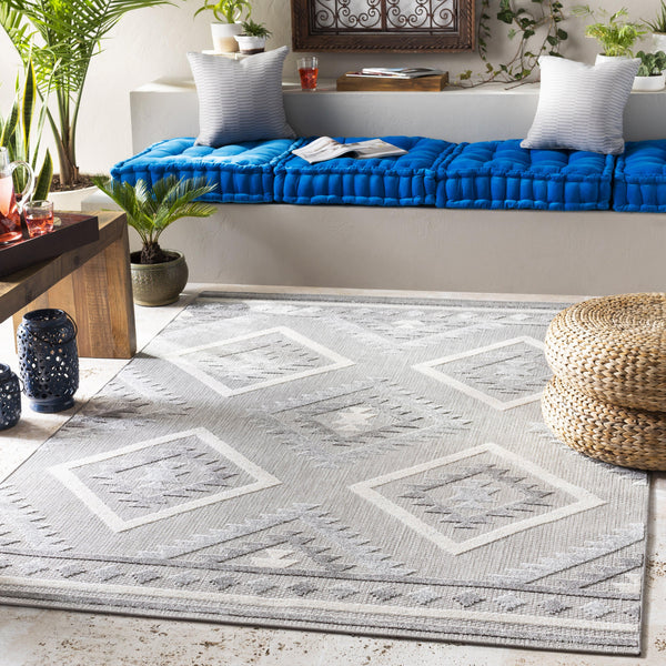 Big Sur Gray Cream indoor/outdoor rug with geometric diamond pattern on a patio.