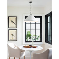 Large Billie concrete pendant light with a rough-hewn texture and flared silhouette, hanging in a bright room.