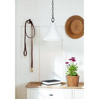 Small Billie concrete pendant light with a bell-shaped silhouette and rough-hewn texture, hanging from a black chain.
