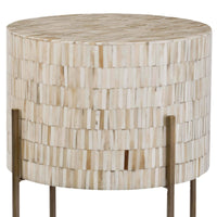 Round bone drum table with intricate inlay and antiqued brass legs.