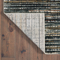 Bowen Black Multi-Colored Abstract Rug with high/low texture, polypropylene blend, and woven backing on wood floor.