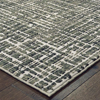 Bowen Grey & Ivory casual rug with a high/low geometric pattern on dark wood flooring.