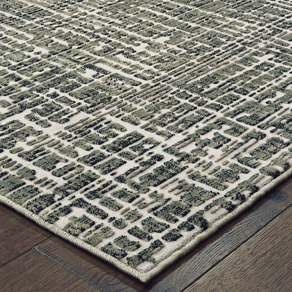 Bowen Grey & Ivory casual rug with a high/low geometric pattern on dark wood flooring.