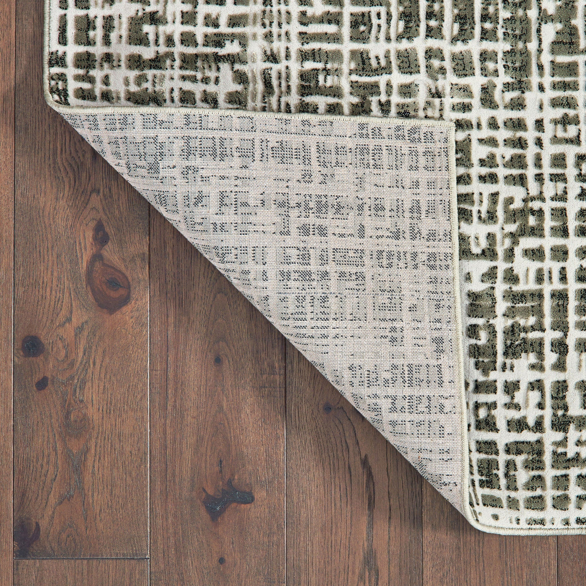 Bowen Grey & Ivory Casual Rug with abstract geometric pattern, showing soft texture and woven polypropylene back on wood floor.