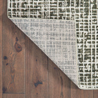 Bowen Grey & Ivory Casual Rug with abstract geometric pattern, showing soft texture and woven polypropylene back on wood floor.