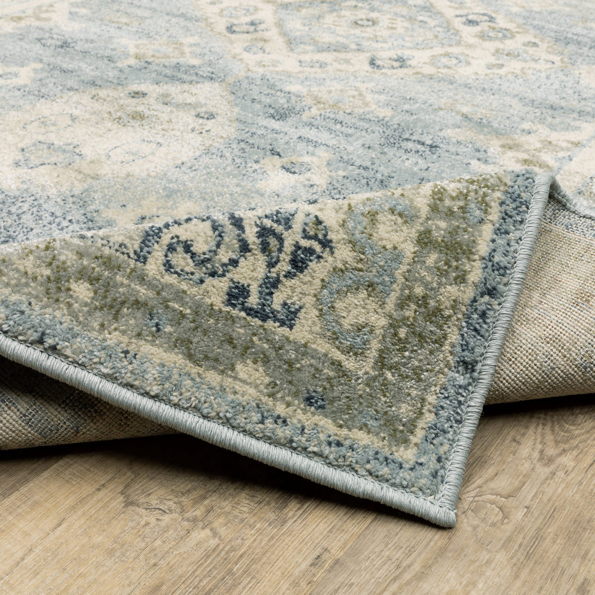 Branson Blue & Beige Traditional Rug, power-loomed polypropylene with classic design, curled corner showing woven back.