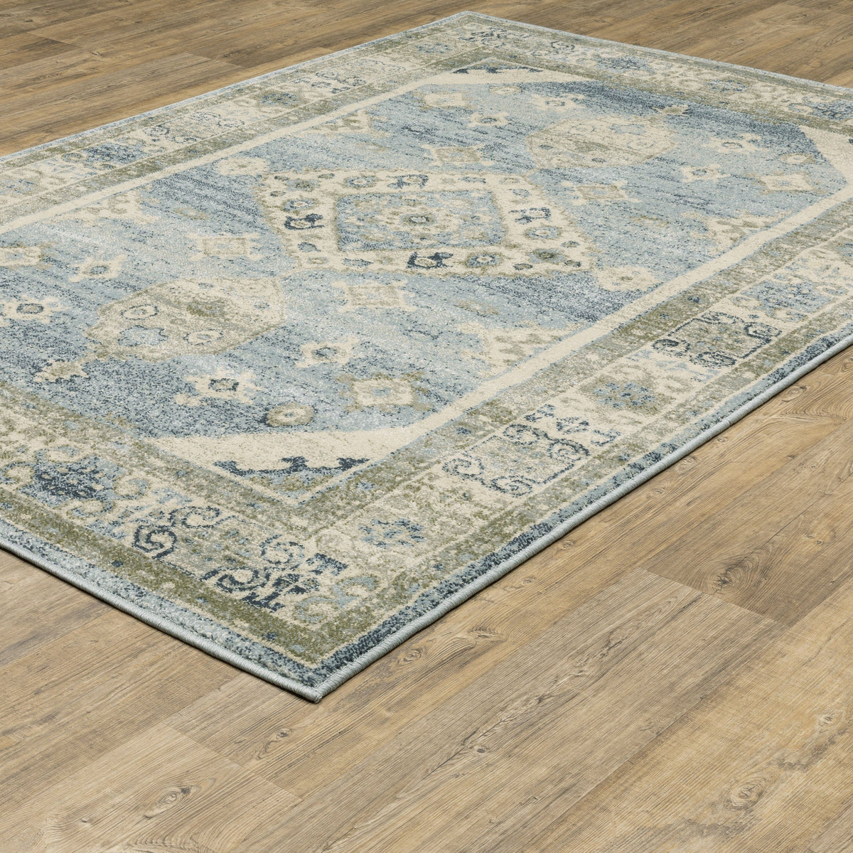 Branson Blue & Beige Traditional Rug, power-loomed polypropylene with classic patterns on a wood floor.