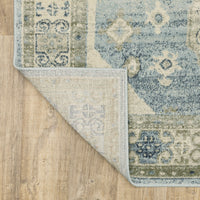 Branson Blue & Beige Traditional Rug, power-loomed polypropylene with classic patterns, corner folded to show woven backing.