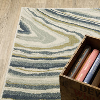 Branson Ivory & Blue Abstract Rug, power-loomed polypropylene with swirling navy, soft blue, moss green, and neutral tones.