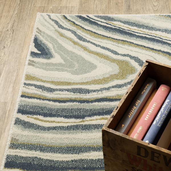 Branson Ivory & Blue Abstract Rug, power-loomed polypropylene with swirling navy, soft blue, moss green, and neutral tones.