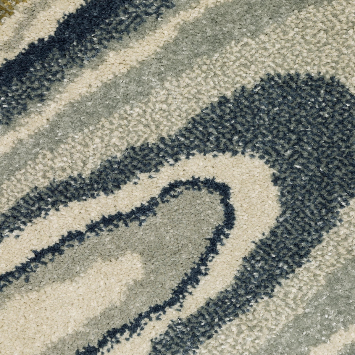 Close-up of Branson Ivory & Blue Abstract Rug, showing power-loomed polypropylene fibers in deep navy, soft blue, and neutral tones.