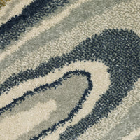 Close-up of Branson Ivory & Blue Abstract Rug, showing power-loomed polypropylene fibers in deep navy, soft blue, and neutral tones.